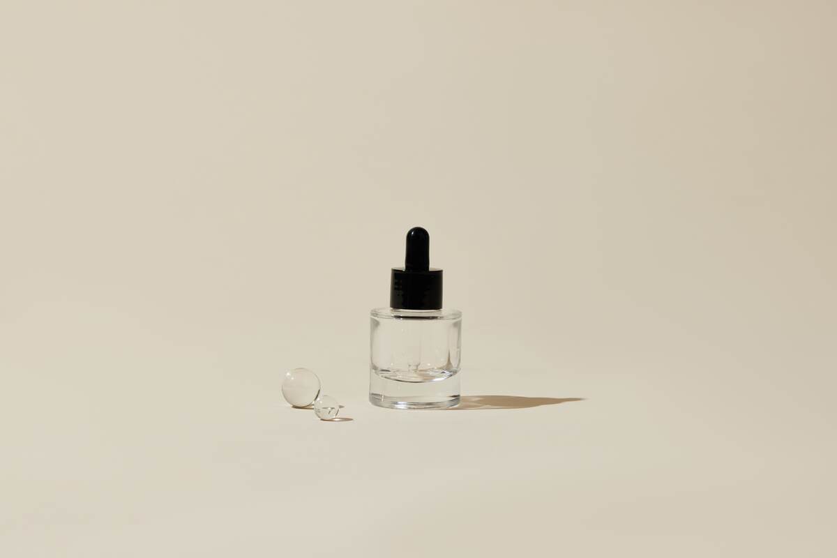 Clear Glass Bottle with Black Pipet Top